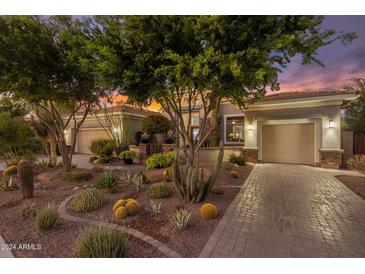 Landscaped front yard with drought-tolerant plants and a brick driveway at 5452 E Windstone Trl, Cave Creek, AZ 85331