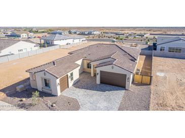 Aerial view of a single-story house with tile roof, two-car garage, and landscaped yard at 13637 W Hackamore Dr, Peoria, AZ 85383