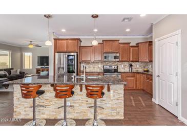 Modern kitchen with granite countertops and wood cabinets at 1914 S 235Th Dr, Buckeye, AZ 85326