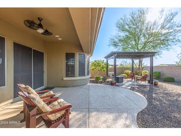 Spacious backyard patio featuring a pergola and fire pit at 31498 N 129Th Dr, Peoria, AZ 85383