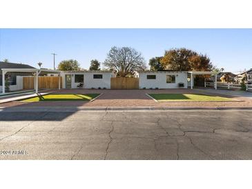 Two charming homes with modern design, featuring covered carports and manicured lawns at 238 S Wilbur Ave, Gilbert, AZ 85233