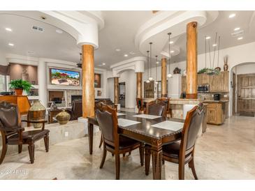 Elegant dining room with a large table and comfortable chairs at 11305 S 195Th Dr, Buckeye, AZ 85326