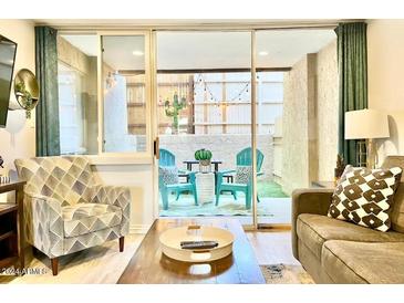 Bright living room with access to a private patio at 7625 E Camelback Rd # B108, Scottsdale, AZ 85251