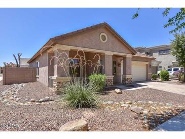 One-story home with a covered porch and rock landscaping at , Goodyear, AZ 85338