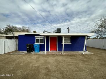 Blue house with red door, white trim, and small covered porch at 1122 E Portland St # B, Phoenix, AZ 85006