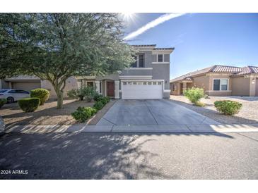 Two-story house with attached garage and well-maintained landscaping at 781 E Cowboy Cove Trl, San Tan Valley, AZ 85143