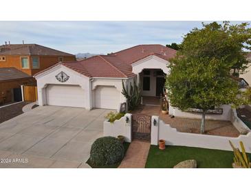 Single-story home with tile roof, two-car garage, and landscaped front yard at 6440 E Odessa St, Mesa, AZ 85215