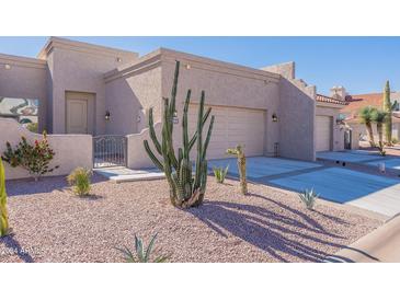 Front exterior with two-car garage and desert landscaping at 8753 E Greenview Dr, Gold Canyon, AZ 85118