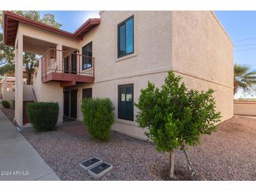 Exterior view of a two-story building with a walkway and landscaping at 455 S Delaware Dr # 120, Apache Junction, AZ 85120