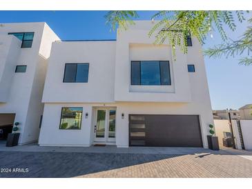 Modern two-story home with sleek design and dark garage door at 2130 E Turney Ave # 4, Phoenix, AZ 85016