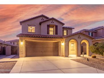 Two-story house with a two-car garage, arched entryway and desert landscaping at 2660 S 172Nd Dr, Goodyear, AZ 85338