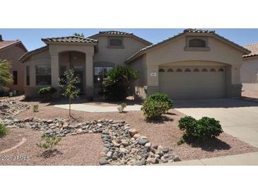 Single story home with two-car garage and rock landscaping at 18071 W Douglas Way, Surprise, AZ 85374