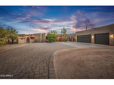 Stunning Southwestern-style home with a large driveway and three-car garage at 15339 E Red Bird Rd, Scottsdale, AZ 85262