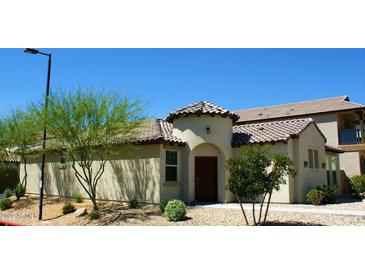 One-story home with Spanish tile roof and desert landscaping at 2927 N Augustine --, Mesa, AZ 85207