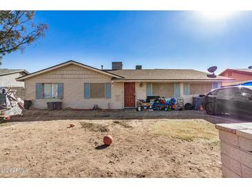 Single-story home with a yard and basketball at 6213 W Palm Ln, Phoenix, AZ 85035