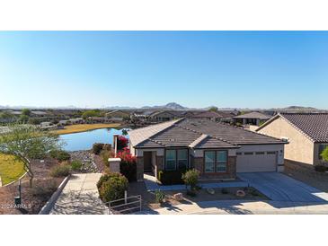 Single-story home with lake view and mountain backdrop at 16914 S 180Th Ave, Goodyear, AZ 85338