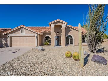 Single-story home with desert landscaping and two-car garage at 19832 N 95Th Ave, Peoria, AZ 85382