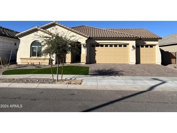 Two-car garage and attractive curb appeal at 16092 W Questa Dr, Surprise, AZ 85387