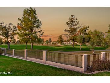 Scenic view of a lush golf course with mature trees at sunset at 1322 W Indigo Dr, Chandler, AZ 85248