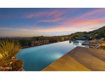Luxury pool with mountain views at sunset at 42383 N 111Th Pl, Scottsdale, AZ 85262