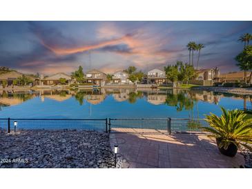 Waterfront property with sunset reflection at 242 E Stonebridge Dr, Gilbert, AZ 85234