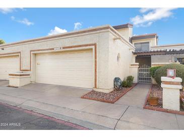 Tan two-story home with attached garage and gated entry at 10836 N 29Th Ave, Phoenix, AZ 85029