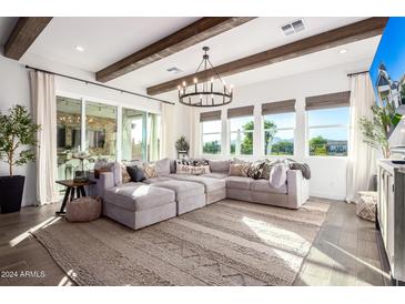 Bright and spacious living room with exposed wooden beams and large windows at 11288 N San Clemente St, Surprise, AZ 85388