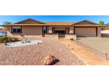 Front view of a charming ranch-style home with a landscaped yard at 17402 N 98Th Ave, Sun City, AZ 85373