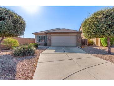 One-story house with a two-car garage and desert landscaping at 41547 W Cheyenne Ct, Maricopa, AZ 85138