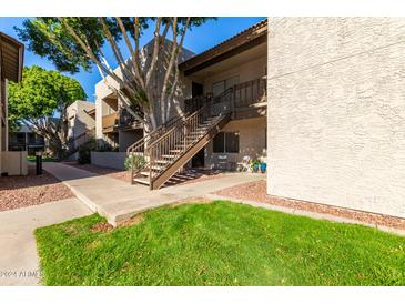 Exterior view of condo building with stairs and landscaping at 520 N Stapley Dr # 193, Mesa, AZ 85203