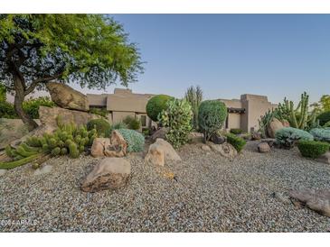 Landscaped front yard with desert plants and large rocks at 24005 N 45Th Dr, Glendale, AZ 85310