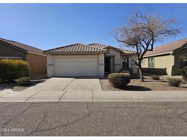 One-story home with a tile roof and two-car garage at 5020 S 25Th Ave, Phoenix, AZ 85041