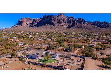 Aerial view of house with solar panels and mountain backdrop at 5365 E Shiprock St, Apache Junction, AZ 85119