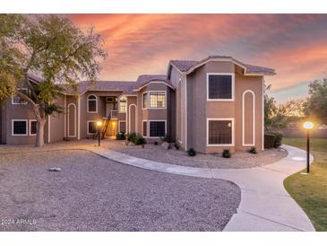 Inviting exterior of a two-story condo building with landscaping and a walkway at 5230 E Brown Rd # 260, Mesa, AZ 85205