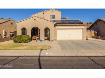Two-story house with solar panels and a two-car garage at 16170 W Port Royale Ln, Surprise, AZ 85379