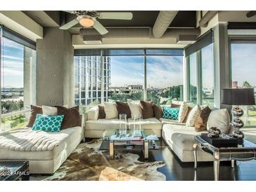 Spacious living room with large windows and sectional sofa at 1 E Lexington Ave # 410, Phoenix, AZ 85012