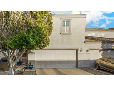 Two-story house with a gray facade and a double garage at 13349 N 87Th Ln, Peoria, AZ 85381