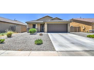 Charming single-story home with a two-car garage and well-manicured front yard at 823 S Silvercreek Ct, Casa Grande, AZ 85122