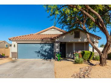 Single-story home with a two-car garage and landscaped front yard at 38617 N Jonathan St, San Tan Valley, AZ 85140