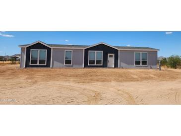 Single-story home with gray and dark gray exterior at 310 N Brower Rd, Maricopa, AZ 85139