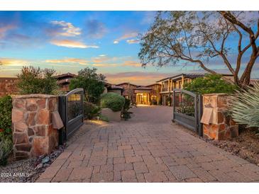 Elegant home with a large courtyard and gated entry at 10612 E Winter Sun Dr, Scottsdale, AZ 85262