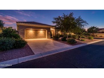 House exterior at night with a two-car garage at 13431 W Los Bancos Dr, Sun City West, AZ 85375