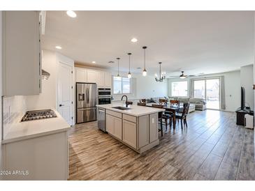 Open concept kitchen with island and dining area at 5623 W Stargazer Pl, Laveen, AZ 85339