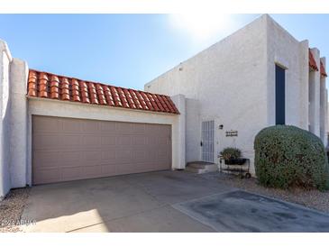Townhouse exterior with attached garage and landscaping at 16053 N 26Th Cir, Phoenix, AZ 85023
