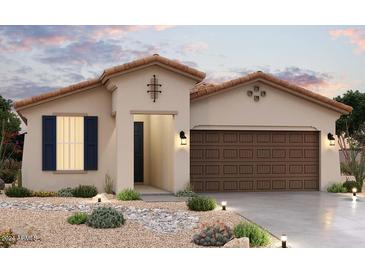 Beautiful Spanish style home with a two car garage and desert landscaping at 21537 W Papago St, Buckeye, AZ 85326