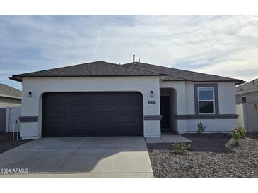 Charming single-story home with a dark-colored garage door and a gray tiled roof at 5601 E Arctic Ln, San Tan Valley, AZ 85140