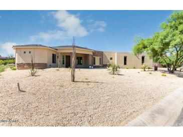 Modern desert home exterior with stone accents and landscaping at 27808 N Desierto Dr, Rio Verde, AZ 85263