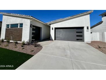 Modern home exterior with two-car garage and landscaped front yard at 3812 W Antelope Way, San Tan Valley, AZ 85144