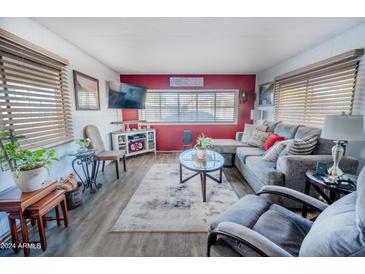 Cozy living room featuring a comfortable sectional sofa and large TV at 8103 E Southern Ave # 245, Mesa, AZ 85209