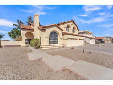 Two-story home with tile roof, arched windows and three-car garage at 2120 N 125Th Ave, Avondale, AZ 85392